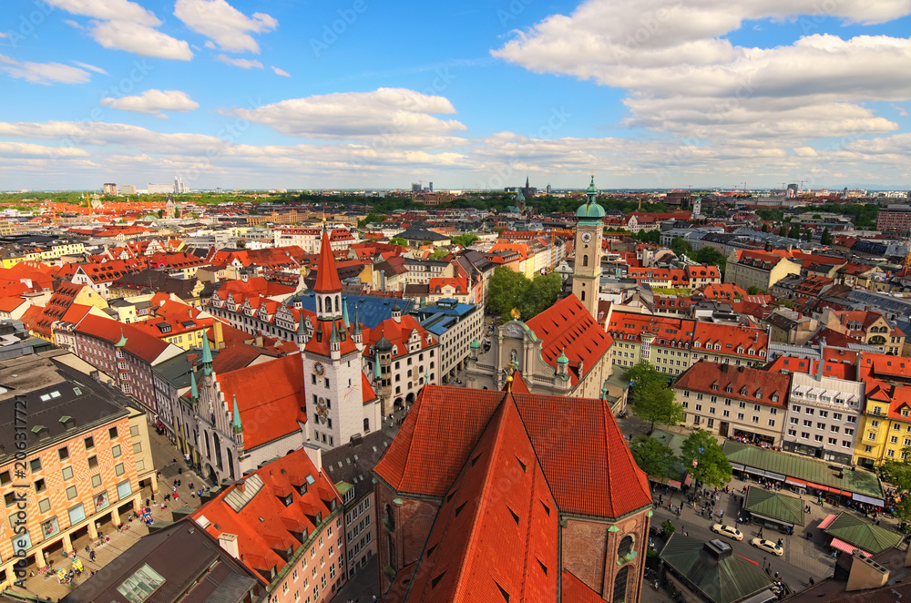 Munich historical center panoramic aerial cityscape. Old City Hall, Heiliggeist Church (Heiliggeistkirche) and red tile roofs of ancient building at spring day. Bavaria, Germany