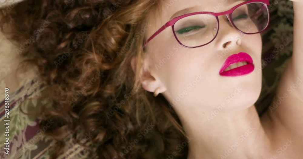 sexy woman in glasses lying in a couch and tries to seduce you. close up portrait sexy woman in glasses lying in a couch and tries to seduce you. close up portrait