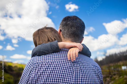 son hugging father