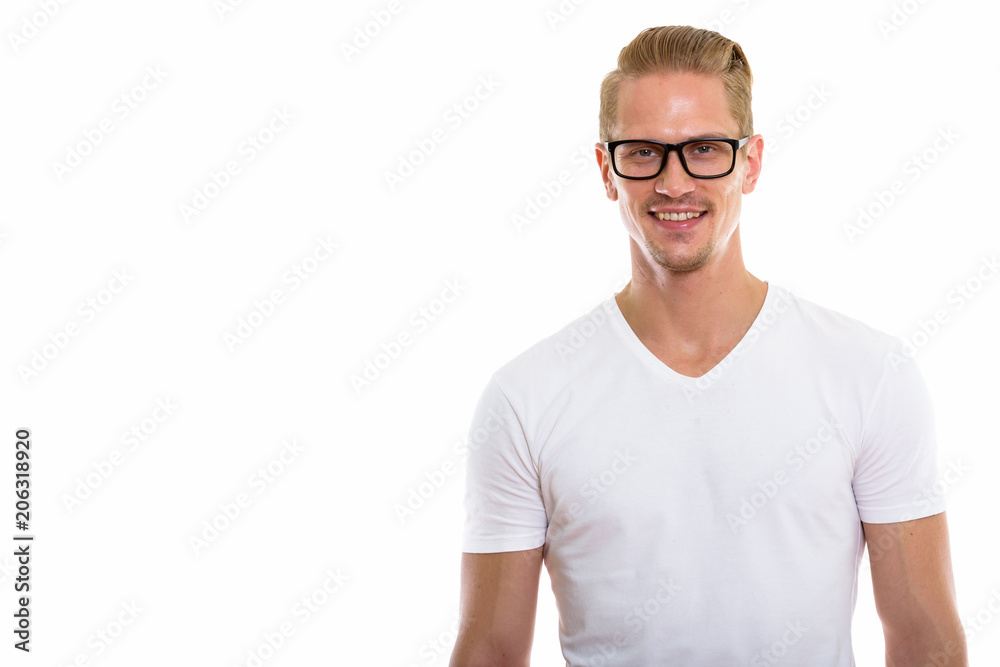 Obraz premium Studio shot of happy young handsome man smiling while wearing ey