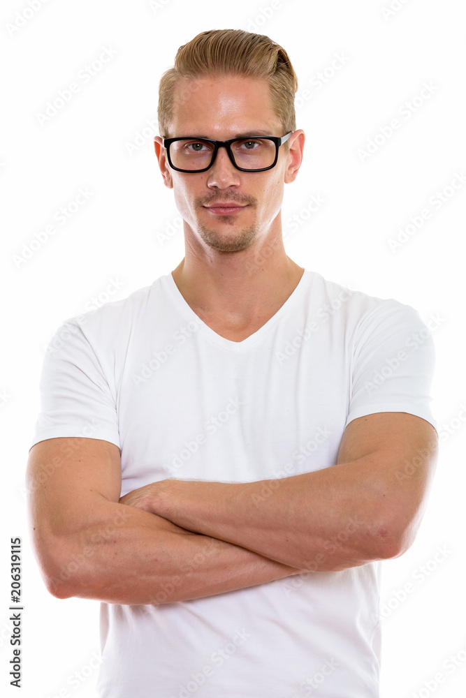 Studio shot of young handsome man wearing eyeglasses with arms c Studio shot of young handsome man wearing eyeglasses with arms c