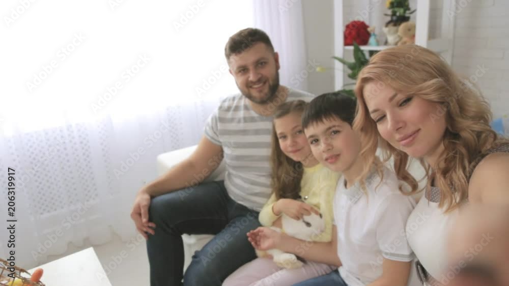 Happy family with two children and rabbit taking selfies. Shooting first-person Happy family with two children and rabbit taking selfies. Shooting first-person