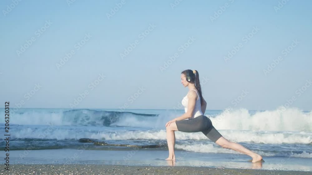 young beautiful sportswoman doing exercises on beach. young beautiful sportswoman doing exercises on beach.