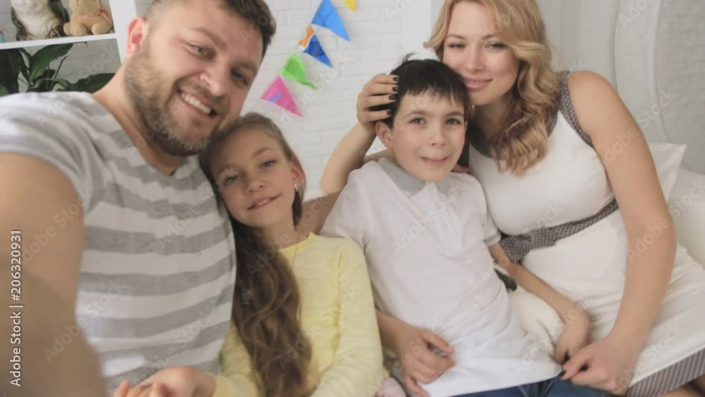 Cheerful family with two children and white rabbit taking selfies. Shooting first-person Cheerful family with two children and white rabbit taking selfies. Shooting first-person