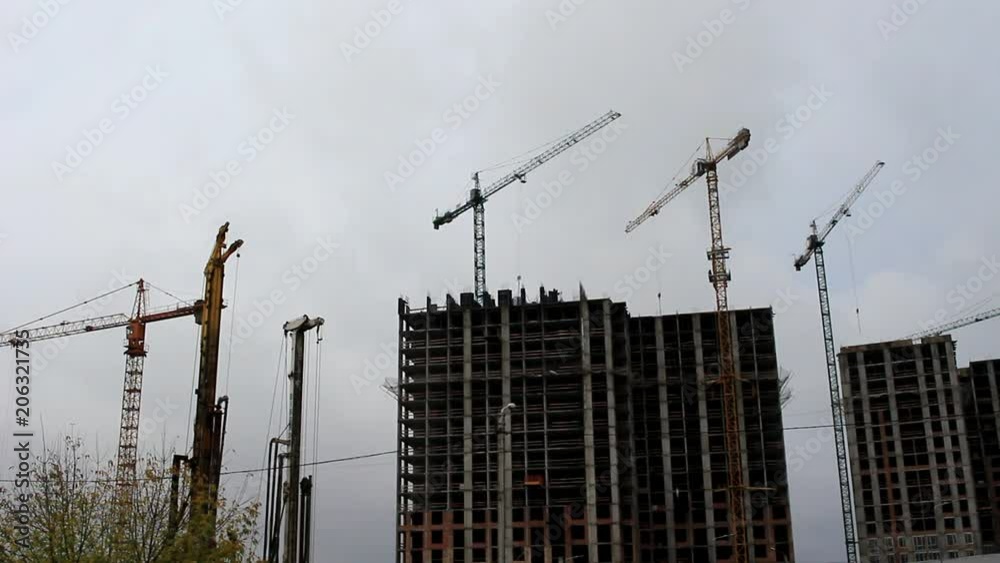 On the construction site, cranes are installed, they are deployed carrying the load in different directions. On the construction site, cranes are installed, they are deployed carrying the load in different directions.