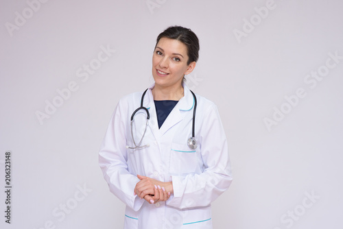 Portrait of a beautiful female doctor on a white background with an endoscope