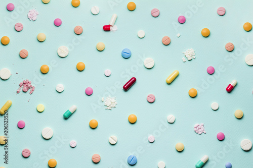 Pretty pills / Creative concept photo of different pills and drugs on blue background.