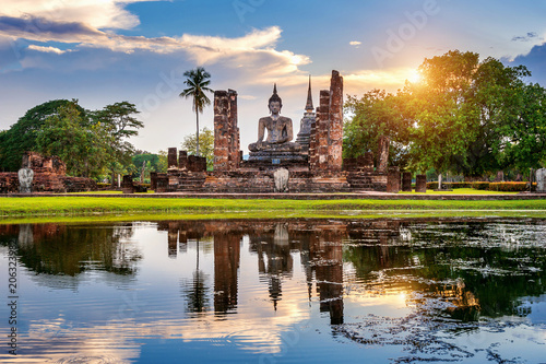 Buddha statue and Wat Mahathat Temple in the precinct of Sukhothai Historical Park, Wat Mahathat Temple is UNESCO World Heritage Site, Thailand.