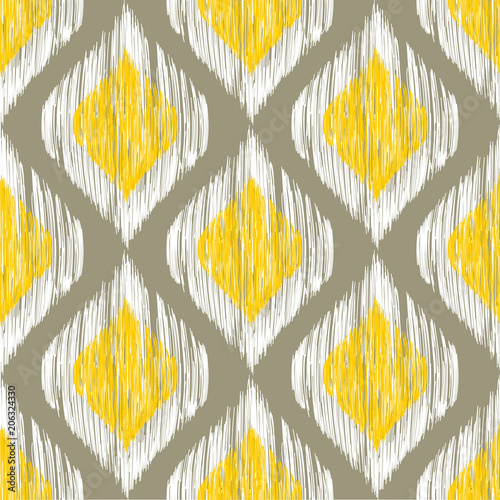 Yellow, white and grey rhomb seamless pattern in native ikat style.