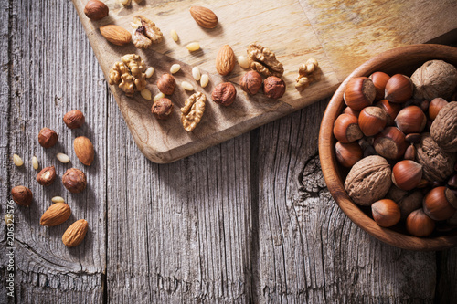 Mixed nuts on old wooden background