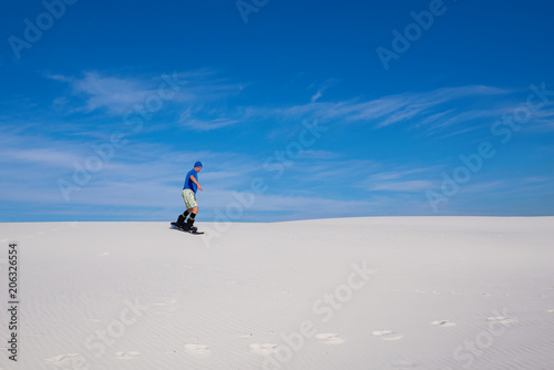 Sand boarding in desert at sunny day