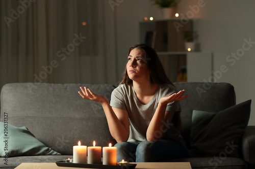 Woman complaining during a blackout at home photo
