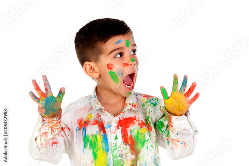 Funny boy with hands and face full of paint