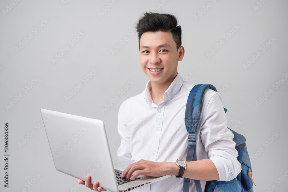 Happy young man using laptop on white background Happy young man using laptop on white background