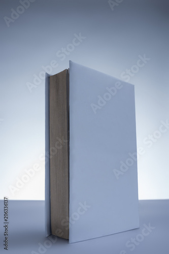 one white book on grey tabletop