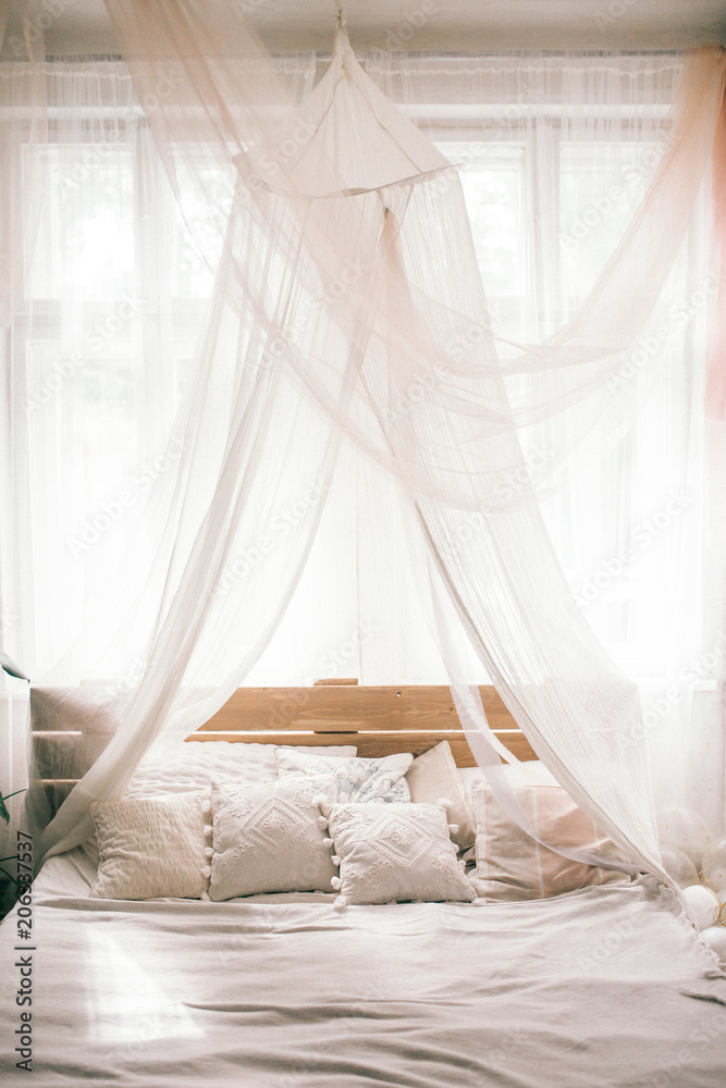 Hotel room, Wedding bed topped with pillows with canopy net. Mattress wedding.