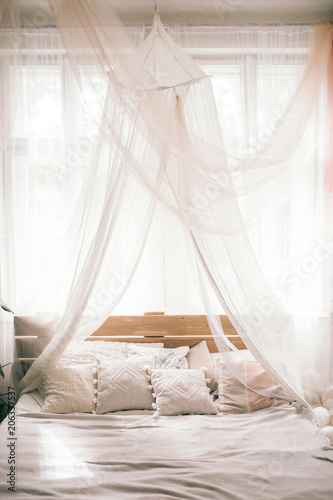 Hotel room, Wedding bed topped with pillows with canopy net. Mattress wedding.
