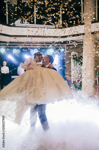 First wedding dance of newlywed. Amazing dancing bride and groom on low light and heavy smoke.  A lot of confetti.