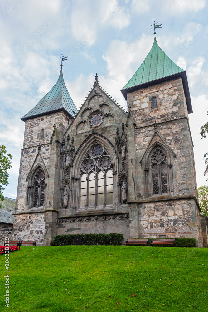 Gothic medieval Stavanger Cathedral with bright green garden, Norway