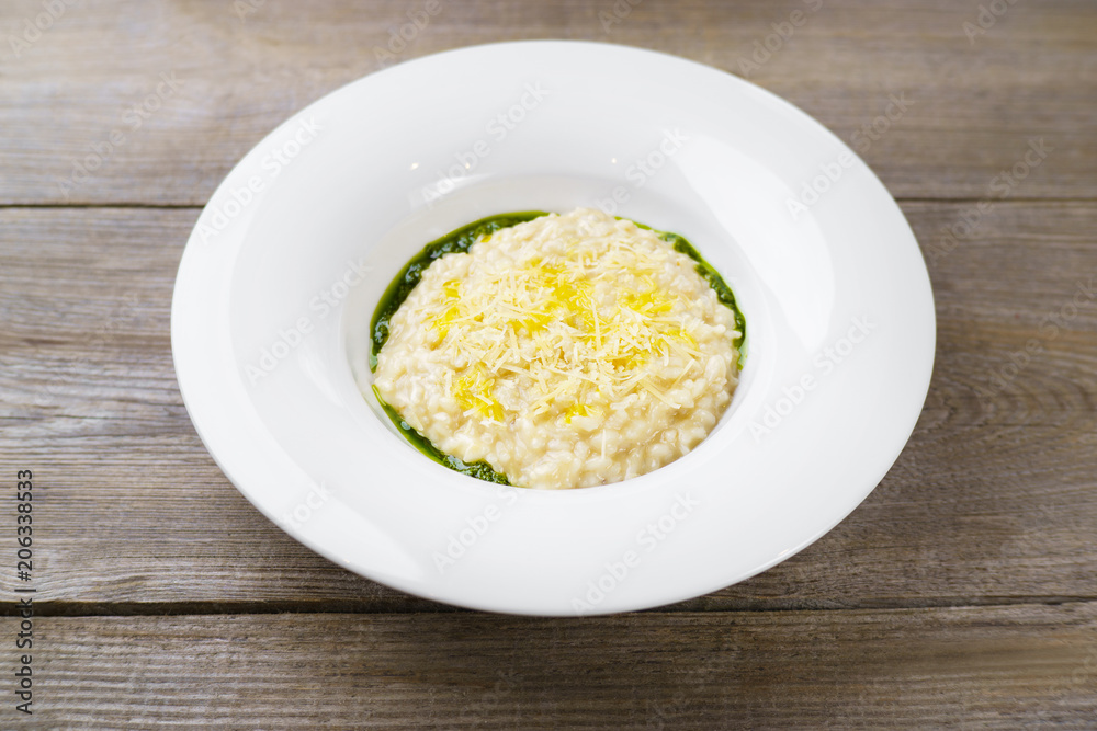 Italian risotto with parmesan and pesto sauce. Vegetarian meals, Mediterranean cuisine, restaurant menu, home cooking