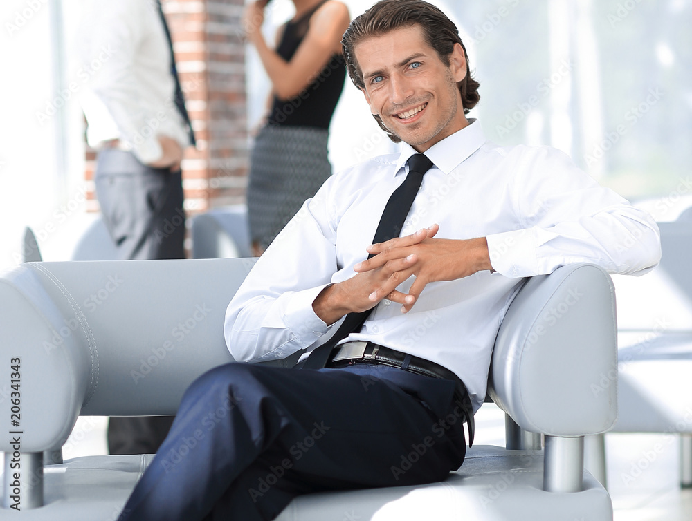 smiling businessman sitting in office chair smiling businessman sitting in office chair