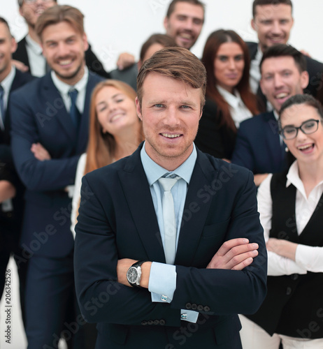 happy businessman standing on background of her business team.