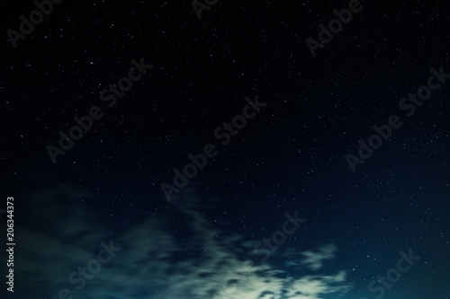 Starry sky and illuminated clouds.