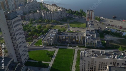 Aerial shooting of the city with modern buildings against the background of the river photo