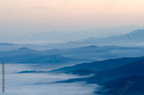 Sunset over mountains and fog © NIPATHORN