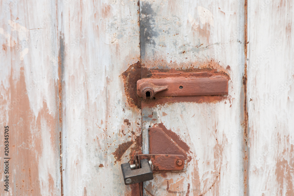 Old rusty padlock on the metal door Old rusty padlock on the metal door