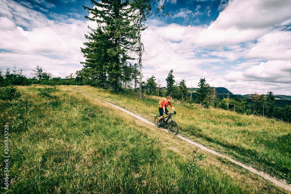 Mountain biking man riding in woods and mountains Mountain biking man riding in woods and mountains