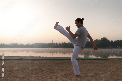 Capoeira on the beach, near lake in the park one performer, at s
