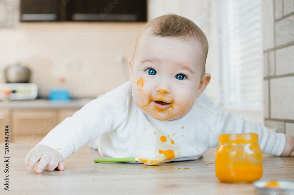 baby with blue eyes crawling, all soiled and smeared in mashed pumpkin, dirty baby with blue eyes crawling, all soiled and smeared in mashed pumpkin, dirty
