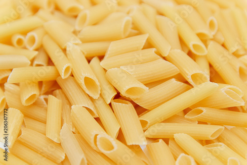 heap of raw pasta. top view. background. close up. italian food or cuisine