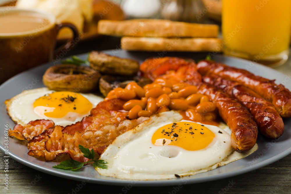 Full English breakfast, with sausage, mushrooms, beans and a fried egg. Full English breakfast, with sausage, mushrooms, beans and a fried egg.