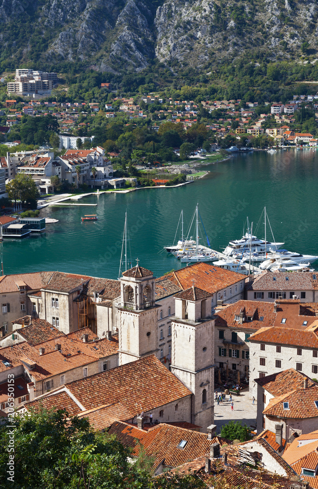 Montenegro. Top view on the picturesque Old Town of Kotor with red tiled roofs (UNESCO World Heritage site) and the two belfries of St. Tryphon's Cathedral (1166)