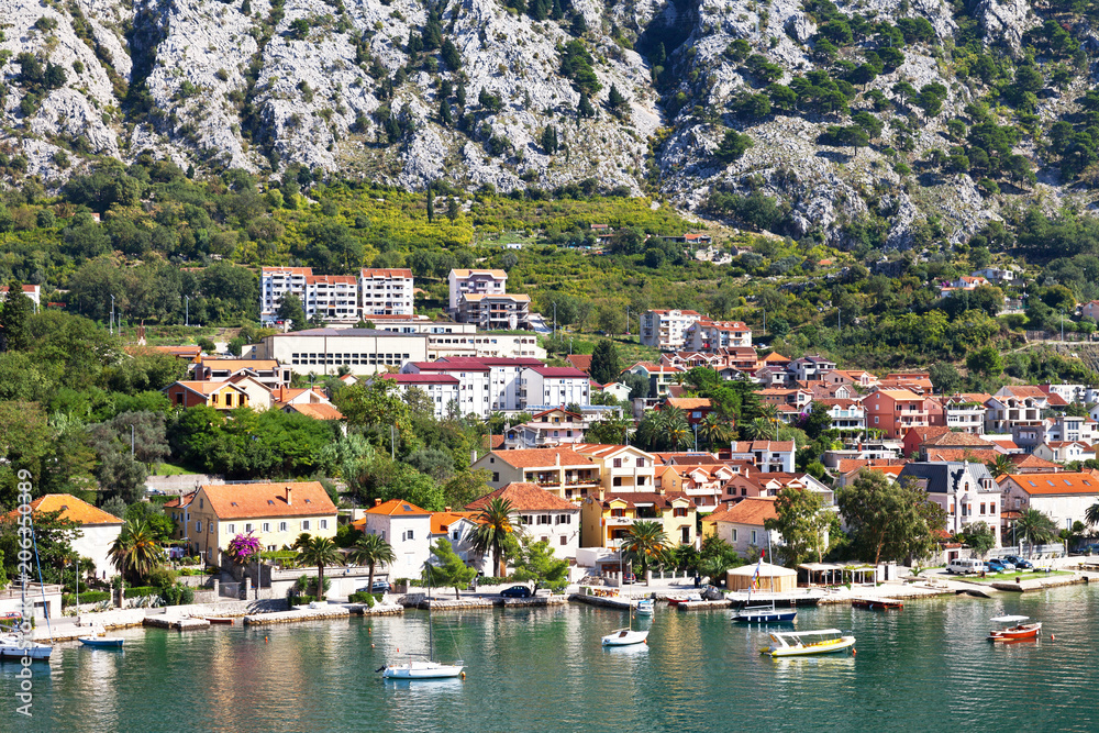 Montenegro. Kotor Bay. A picturesque view of the embankment of Dobrota town on a sunny summer day