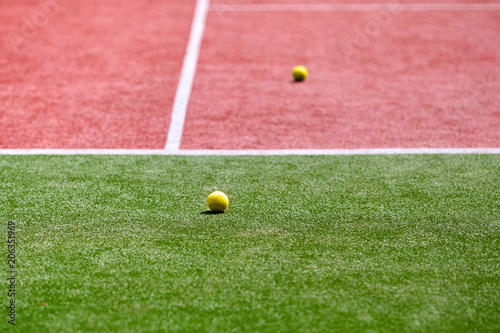 Two tennis balls on the tennis court. © SKfoto