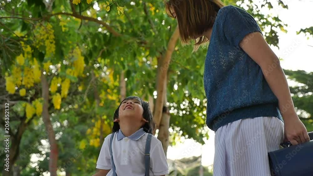 Asian mother  playing with her son in the park slow motion 