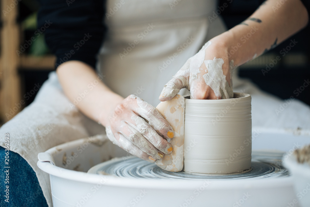 Handcrafted on a potter's wheel,Hands make clay from various items for home and sale in the store and at the exhibition, ceramic items are made in hand, the clay billet becomes a ceramic dish