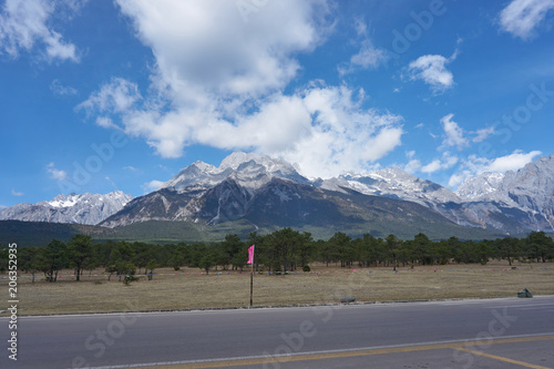Landscape view of Jade Dragon Snow Mountain with blue sky and could. It's famous place for travel.