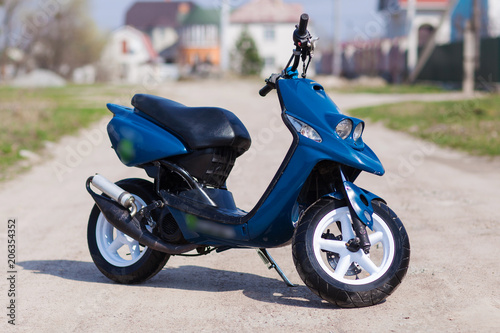 Blue modern scooter on the gravel road