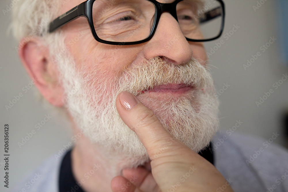 Elderly man with white hair and beard close up. Close up portrait of old  man with glasses getting his white mustache wiped by his wifes hand. Stock  Photo | Adobe Stock