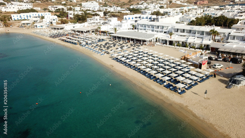 Fototapeta premium Aerial drone bird's eye view photo of famous organized with sun beds emerald clear water beach of Ornos in island of Mykonos, Cyclades, Greece
