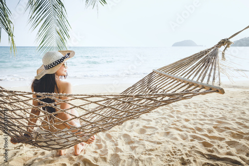 Happy woman relaxing in hammock