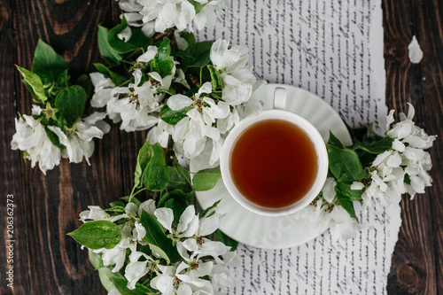 Cup of tea, book, flowers 
