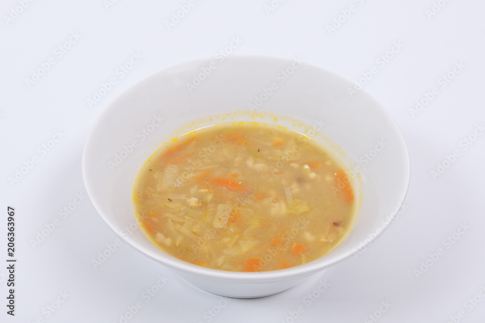 Soup with pasta and vegetables on a white Soup with pasta and vegetables on a white