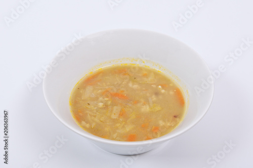 Soup with pasta and vegetables on a white