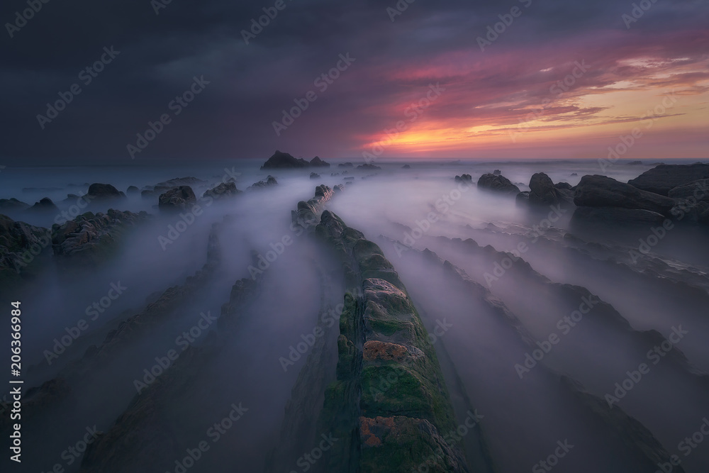 flysch rocks in barrika beach at sunset