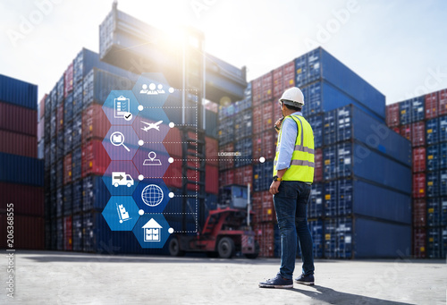 Foreman control loading Containers box from Cargo freight ship for import export photo
